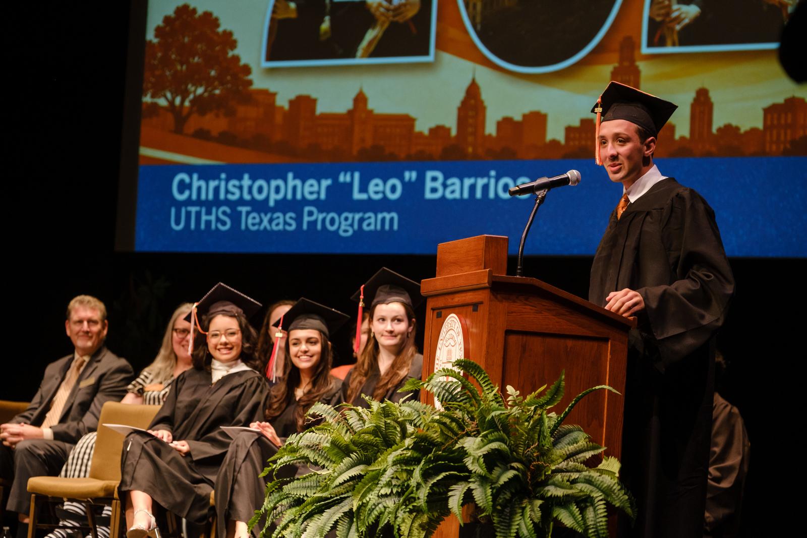 UT High School speaker at the podium on stage