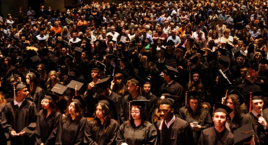 UT High School graduation day at Bass Concert Hall - wide shot of a full auditorium.