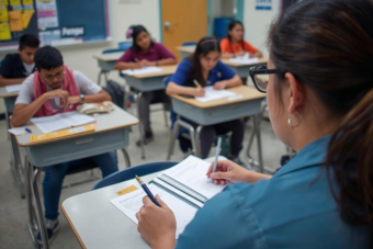 A teacher proctoring an exam for a classroom of students.