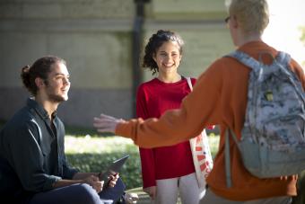 Three students chatting on UT's campus