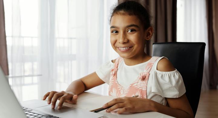 A happy student at her computer