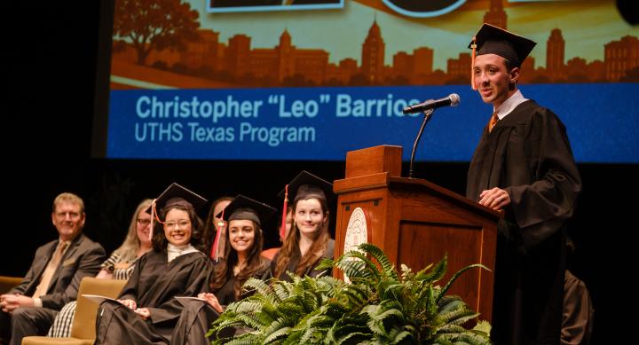 UT High School speaker at the podium on stage